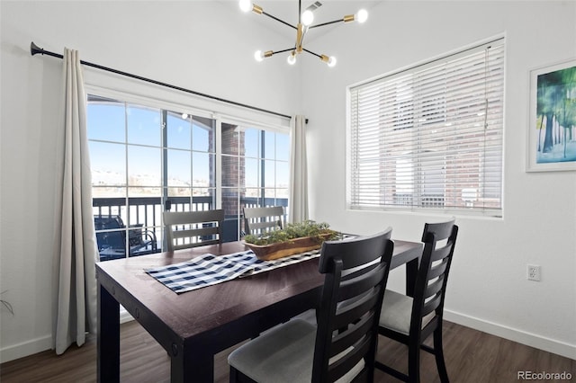 dining room with a notable chandelier and dark hardwood / wood-style flooring