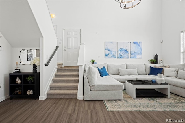 living room featuring a towering ceiling and hardwood / wood-style floors