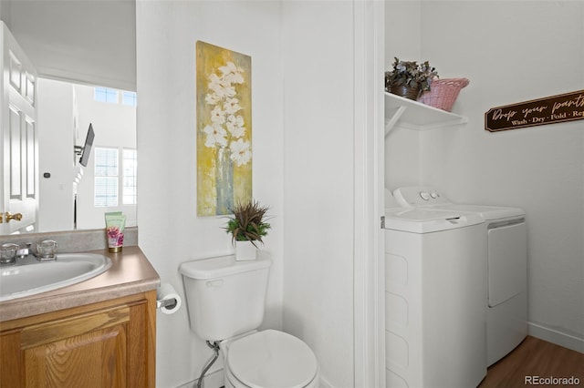 bathroom featuring vanity, toilet, washer and clothes dryer, and wood-type flooring