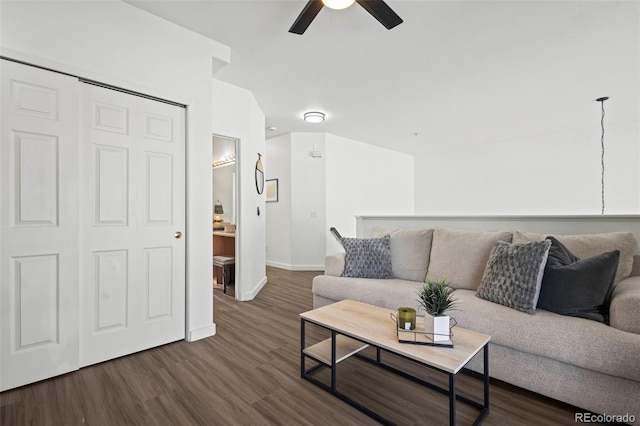 living room featuring dark hardwood / wood-style floors and ceiling fan