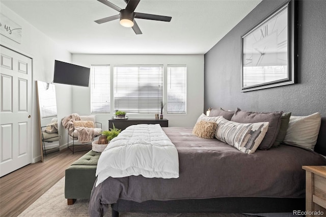 bedroom with wood-type flooring and ceiling fan