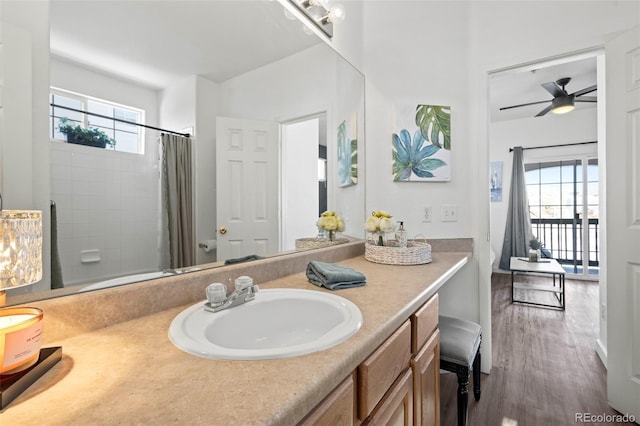 bathroom featuring vanity, hardwood / wood-style floors, a healthy amount of sunlight, and ceiling fan