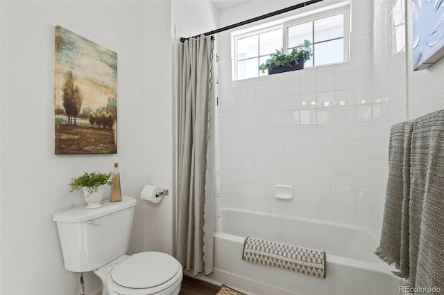 bathroom with shower / tub combo with curtain and toilet