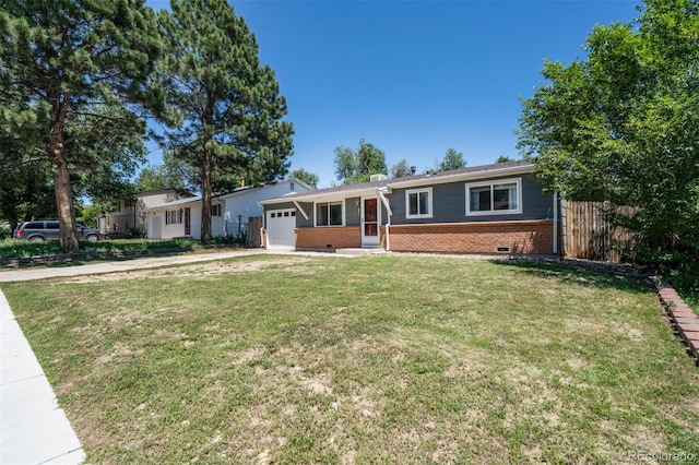 ranch-style home featuring a front yard and a garage