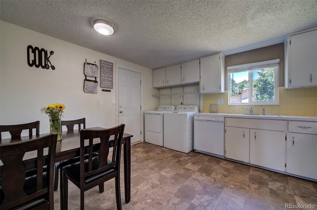 kitchen featuring white dishwasher, white cabinetry, washer and clothes dryer, sink, and light tile floors