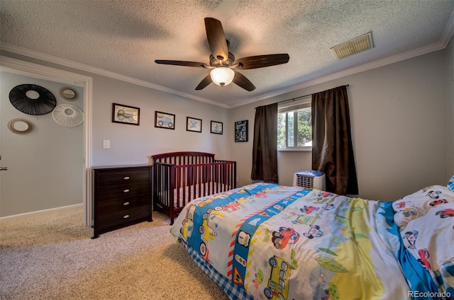 carpeted bedroom featuring ceiling fan, a textured ceiling, and ornamental molding