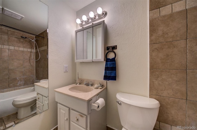 full bathroom featuring tiled shower / bath combo, toilet, and large vanity