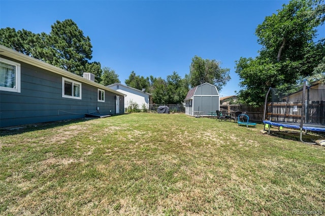 view of yard with a storage unit and a trampoline