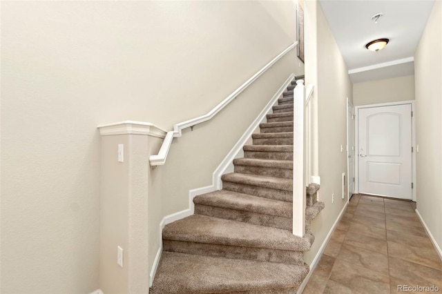 staircase with tile patterned flooring and baseboards