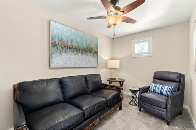 living room featuring carpet floors, baseboards, and a ceiling fan