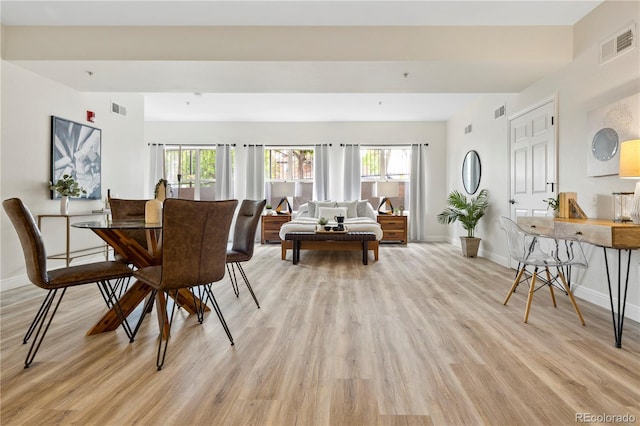 dining space with plenty of natural light and light hardwood / wood-style floors