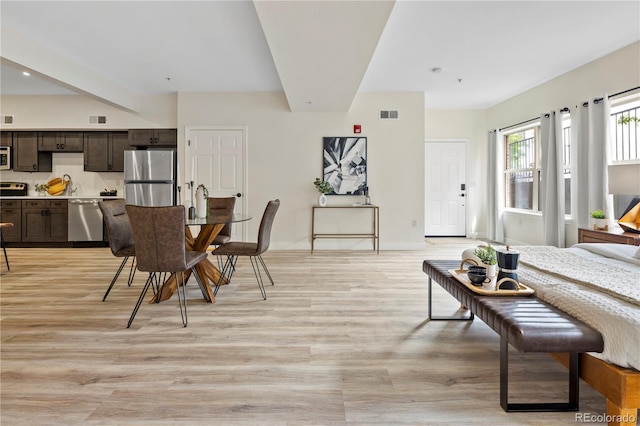 dining space with sink and light wood-type flooring