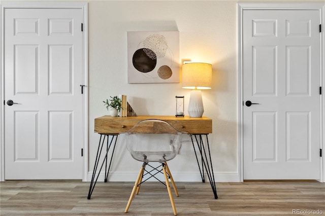 home office with hardwood / wood-style flooring