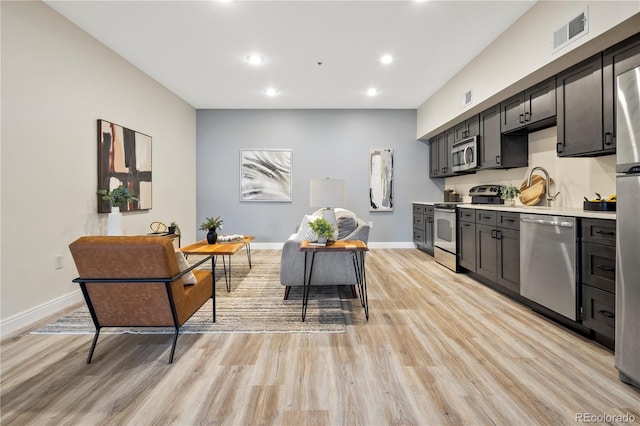 kitchen featuring stainless steel appliances and light hardwood / wood-style floors