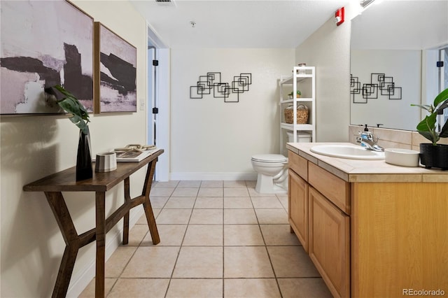 bathroom featuring tile patterned flooring, vanity, and toilet