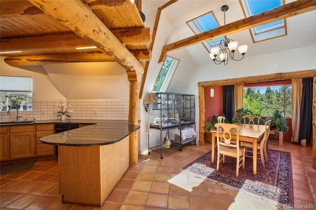 dining area featuring beamed ceiling, sink, light tile floors, and a skylight