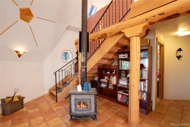 staircase with tile flooring and a wood stove