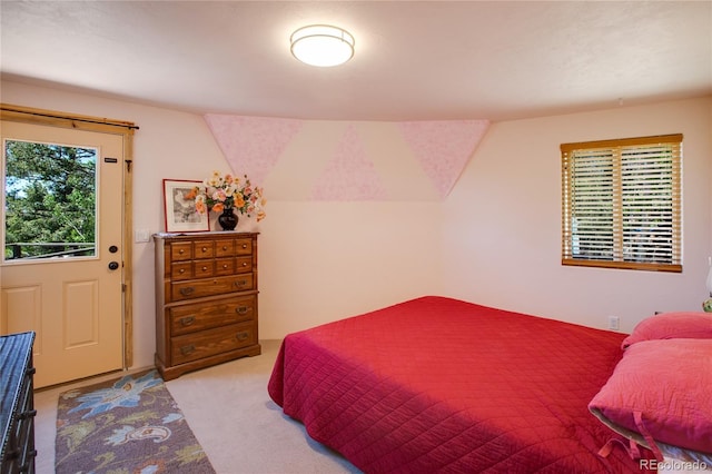 bedroom featuring light carpet and lofted ceiling