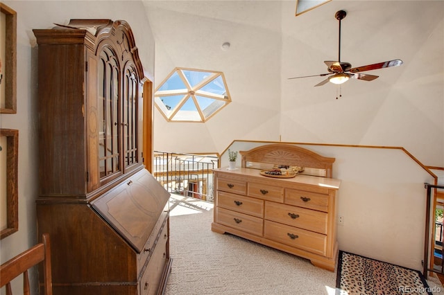 bedroom with light colored carpet and lofted ceiling