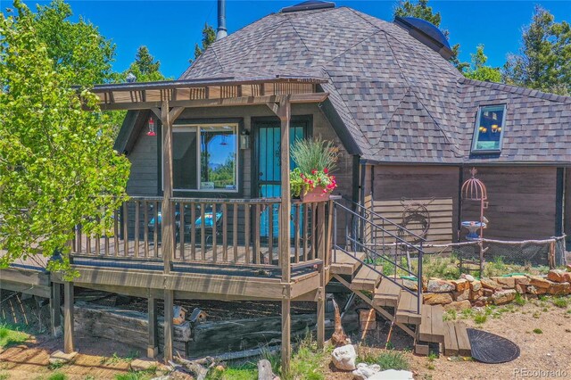 rear view of house featuring a deck