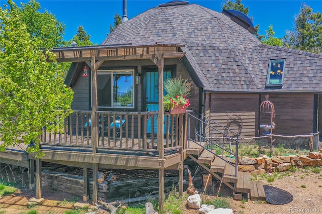 47 Aspen Rd, Woodland Park, CO 80863 - back of property featuring a shingled roof and a wooden deck