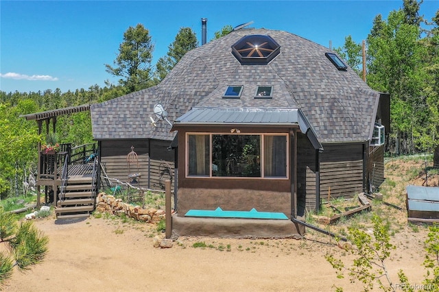 47 Aspen Rd, Woodland Park, CO 80863 - view of front of property featuring a wooden deck, roof with shingles, and an outdoor fire pit
