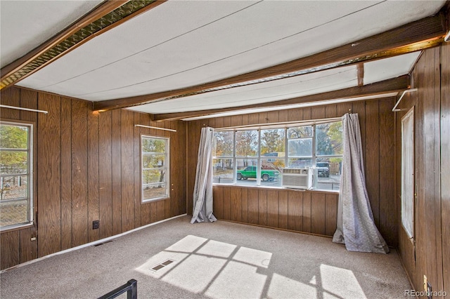 interior space with beamed ceiling and wooden walls