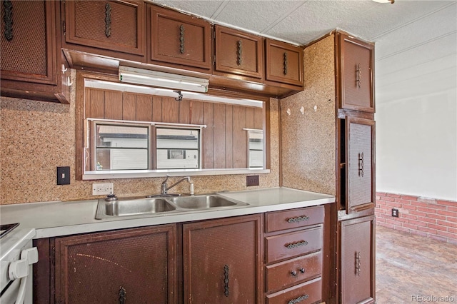 kitchen featuring white stove and sink