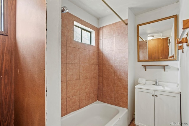 bathroom featuring vanity and tiled shower / bath