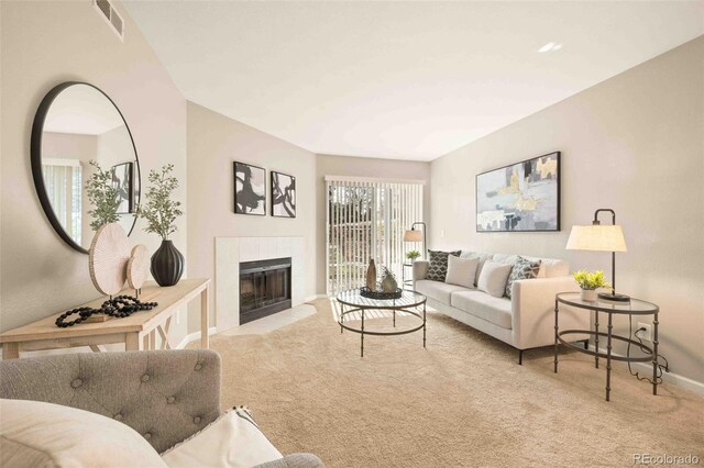 13085 W Cedar Dr Unit 114, Lakewood, CO 80228 - living room with a tiled fireplace, carpet, baseboards, and visible vents