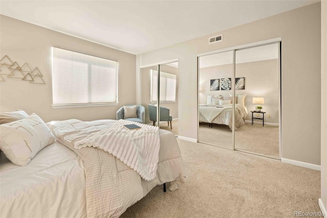 13085 W Cedar Dr Unit 114, Lakewood, CO 80228 - bedroom featuring baseboards, visible vents, two closets, and carpet floors