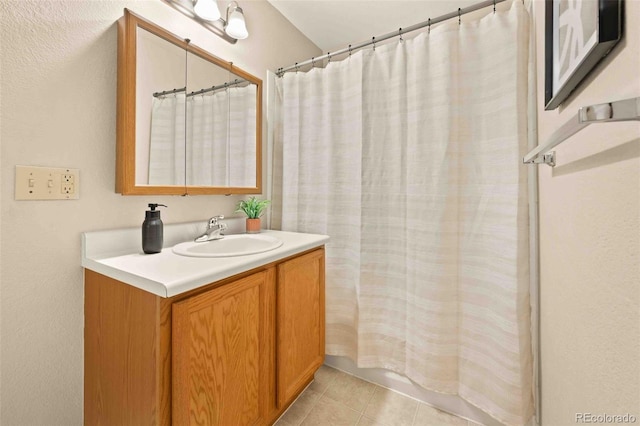 13085 W Cedar Dr Unit 114, Lakewood, CO 80228 - bathroom with tile patterned floors, vanity, and a shower with shower curtain