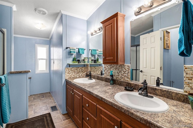 bathroom with ornamental molding, backsplash, and a sink