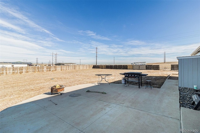 view of patio / terrace featuring an outdoor fire pit, grilling area, and a fenced backyard