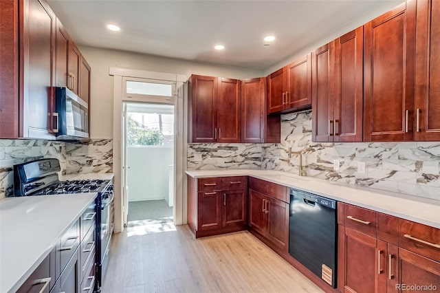 575 N Marion St, Denver, CO 80218 - kitchen featuring appliances with stainless steel finishes, light wood-type flooring, light countertops, tasteful backsplash, and recessed lighting