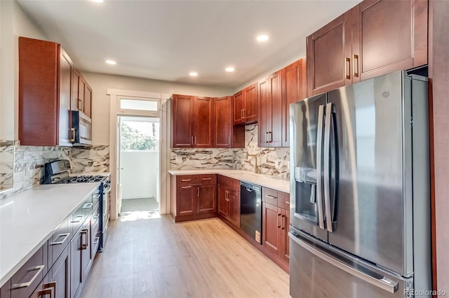 575 N Marion St, Denver, CO 80218 - kitchen with stainless steel appliances, light wood finished floors, light countertops, decorative backsplash, and recessed lighting