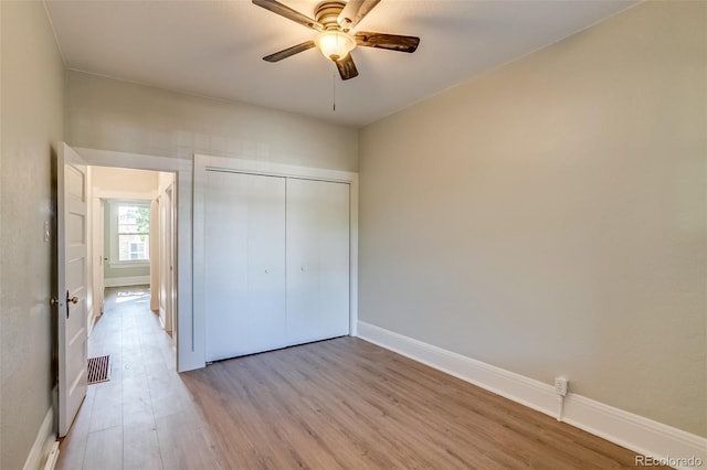 575 N Marion St, Denver, CO 80218 - unfurnished bedroom with light wood-style flooring, a closet, and a ceiling fan