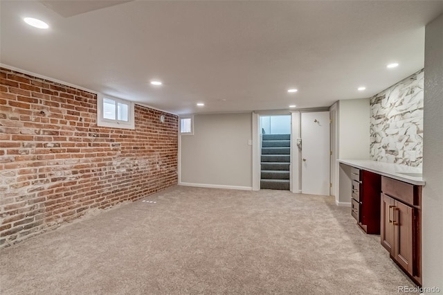 575 N Marion St, Denver, CO 80218 - below grade area featuring brick wall, stairs, recessed lighting, and light carpet