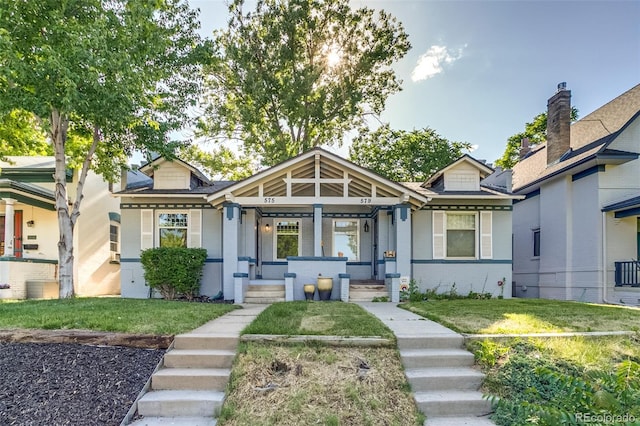 575 N Marion St, Denver, CO 80218 - bungalow-style house featuring covered porch, brick siding, and a front yard