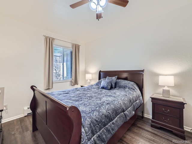 bedroom featuring dark wood-type flooring, a baseboard heating unit, and ceiling fan