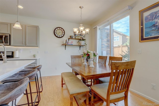 dining area featuring a chandelier and light hardwood / wood-style flooring