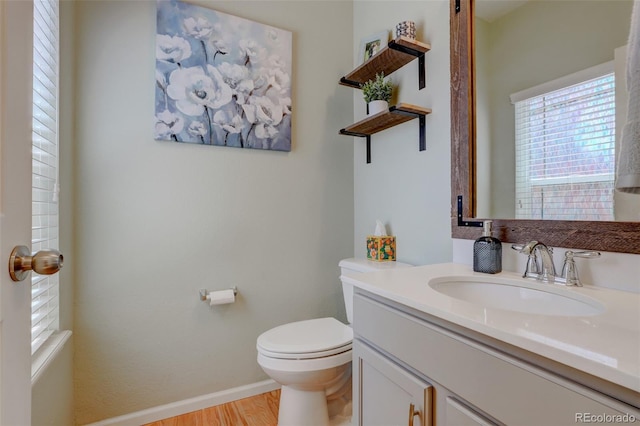 bathroom featuring hardwood / wood-style floors, vanity, and toilet