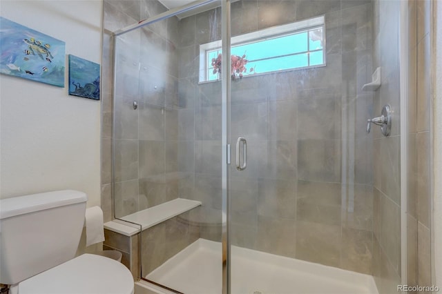 bathroom featuring toilet and an enclosed shower