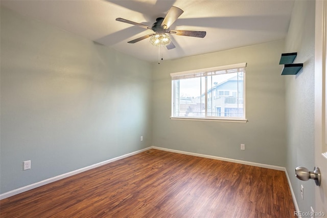 spare room featuring ceiling fan and dark hardwood / wood-style flooring