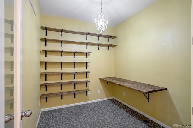 mudroom featuring a notable chandelier