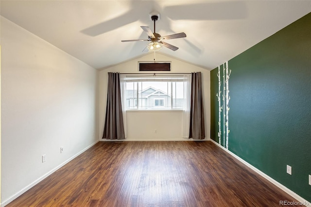 empty room with vaulted ceiling, dark wood-type flooring, and ceiling fan