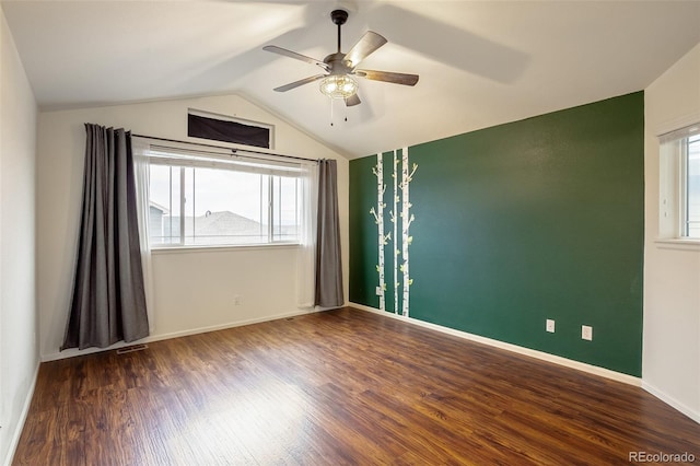 empty room with ceiling fan, dark wood-type flooring, and lofted ceiling