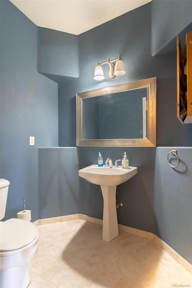 bathroom featuring tile patterned floors and toilet