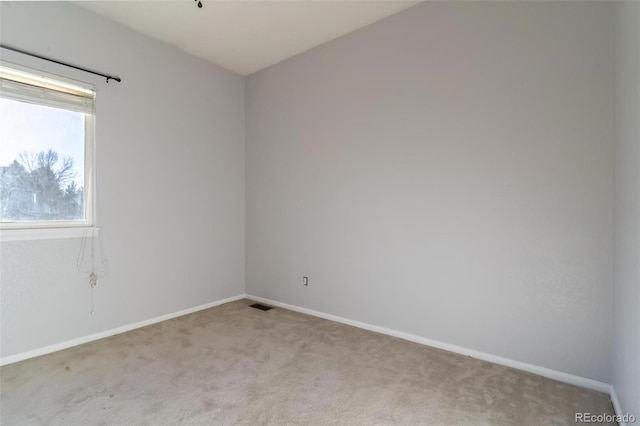 unfurnished room with light colored carpet