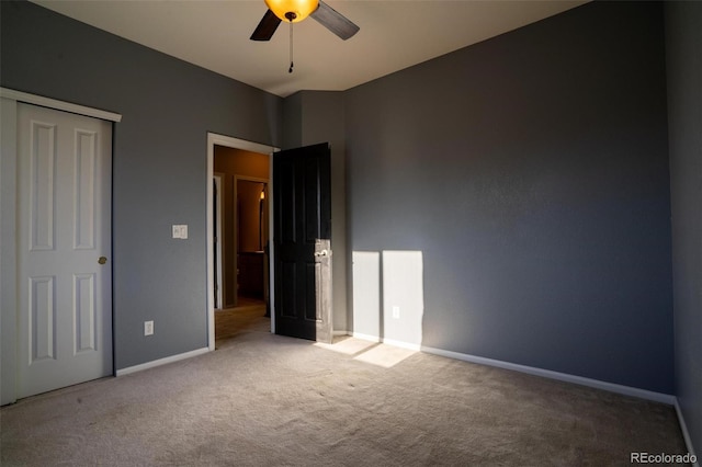 unfurnished bedroom with carpet flooring, ceiling fan, and a closet